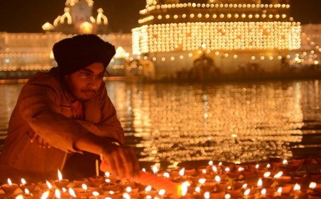An Indian man lights a candle during the 2012 Diwali festival in India/PHOTO: AFP